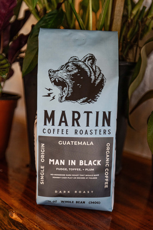 Man in Black  A no-nonsense dark roast that would make Johnny Cash play an encore at Folsom. Single-origin Guatemala Organic by nature Dark Roast Tasting notes: Fudge, Toffee, + Plum Elevation 1400 - 1600 MASL Process Washed Cultivar Bourbon, Caturra www.MartinCoffeeRoasters.com